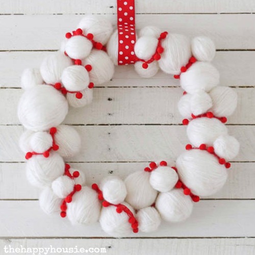 Adorable quick and easy yarn snowball diy christmas wreath at thehappyhousie.com 6