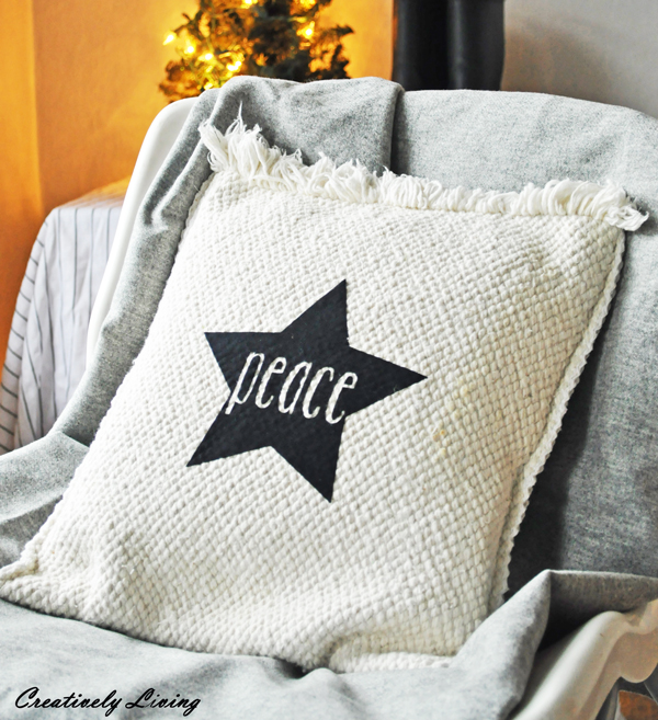 Peace Christmas pillow in black and white with a star.